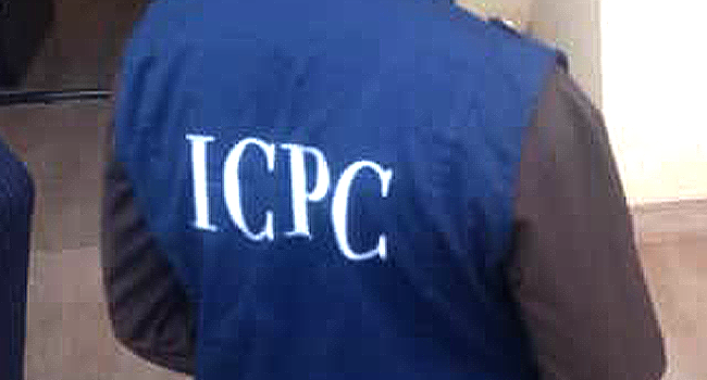 Person wearing a blue vest with ICPC on the back.