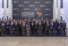 Group of dignitaries in formal attire posing on a stage in front of an Africa Forward Summit backdrop, Nairobi, Kenya (May 11–12, 2026).