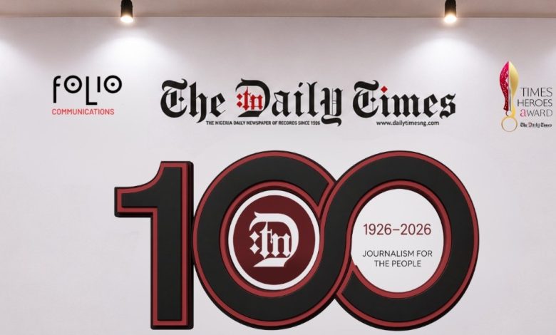 Daily Times - The Times of Abuja Banner celebrating 100 years of The Daily Times (1926–2026) with Folio Communications logo on a white wall.