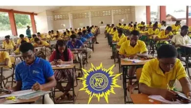 Students in yellow uniforms sit at desks taking an exam in a large classroom; a WAEC logo is visible in the center foreground.