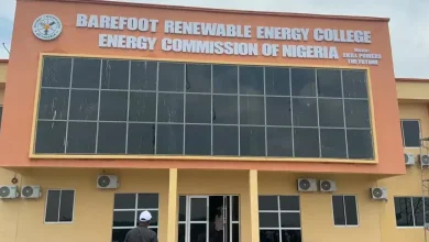 Barefoot renewable energy - The Times of Abuja Front view of Barefoot Renewable Energy College building with an orange facade and a large sign reading 'Barefoot Renewable Energy College – Energy Commission of Nigeria' above the glass facade.