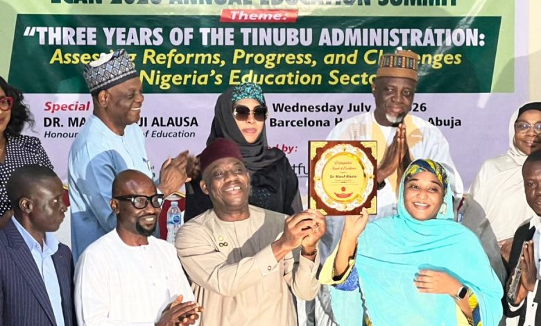 ECAN education summit - The Times of Abuja Group of people on stage at an education summit award ceremony, banner behind reads ECAN 2026 Annual Education Summit with a plaque being handed to a woman in turquoise hijab and scarf.