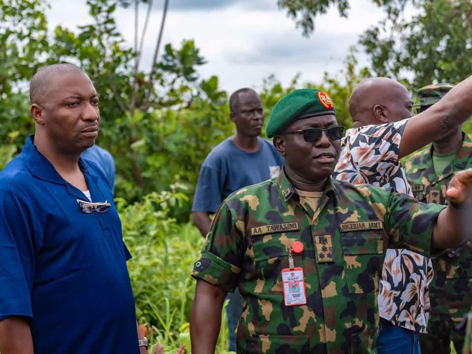 Inspection of Kwara battalion camp site - The Times of Abuja Military officer in camouflage uniform and green beret points and speaks to a small group outdoors.
