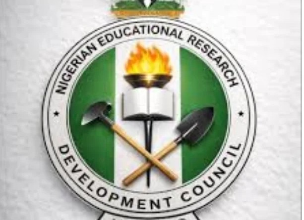 Logo of the Nigerian Educational Research Development Council: a green‑white‑green circular emblem with a burning torch over an open book and crossed hammer and shovel, surrounded by the organization’s name.