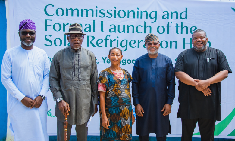 PINDs coldhub - The Times of Abuja Five people pose in front of a banner that reads 'Commissioning and Formal Launch of the Solar Refrigeration Hub' at an event.