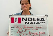 Mugshot of a woman holding a metal ID board with handwritten personal details: name Will Jessica Ann, age 38, female, drug heroin.